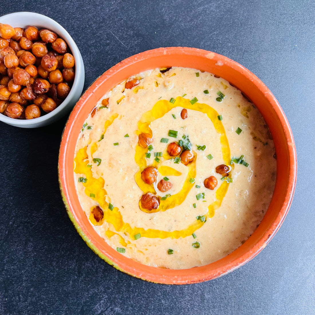 Creamy Cauliflower Soup with Chickpeas CroutonsIndulge in a comforting and savory meal with our Creamy Cauliflower Soup with Chickpeas Croutons. Bursting with robust flavors and a creamy vegetable broth, this vegan soup is a healthy and quick option. Enjoy the taste of cheesy goodness in every spoonful with the added benefits of nutrition and satisfaction.