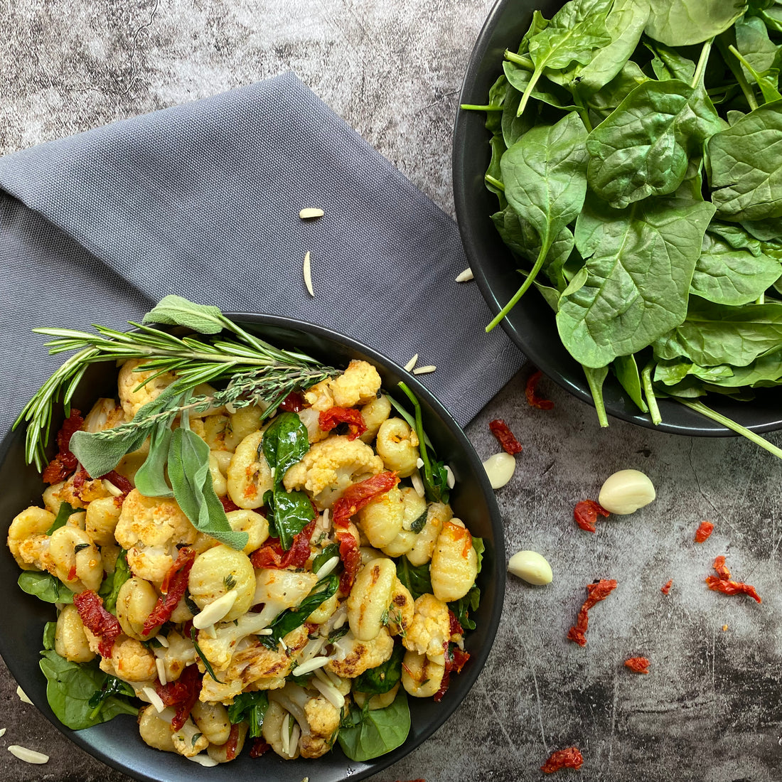 Crispy Gnocchi and Cauliflower Skillet Simple, yet tasty dish of gnocchi, cauliflower, kale and sun-dried tomatoes sautéed in garlic-herb Earth Balance butter, topped with toasted slivered almonds.